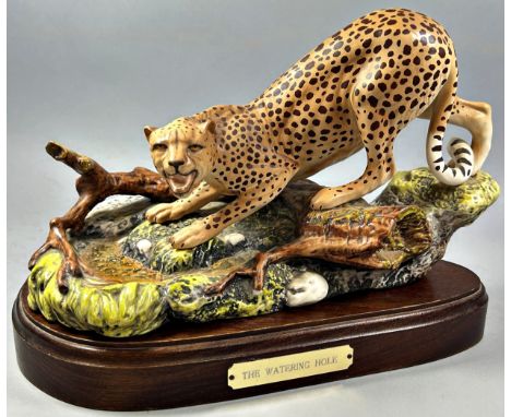 A ceramic model of a Royal Doulton Leopard 'The Watering Hole' set on a wooden plinth, together with a Beswick model of a Jag