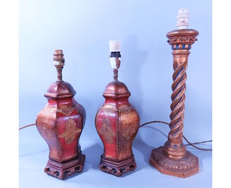 A pair of decorative wooden painted table lamps in a red and gold finish and a wooden gold and blue twisted column table lamp