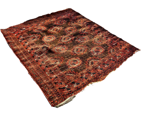 An old Afghan carpet with rows of elephant medallions, on a red ground, faded and worn, 185cm x 155cm approximately