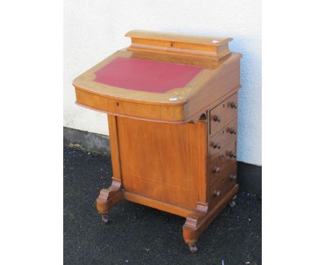 A Victorian walnut davenport with inlaid detail