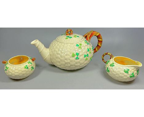 A Belleek porcelain associated tea true comprising large teapot, first period black mark, together with a milk jug and twin-h