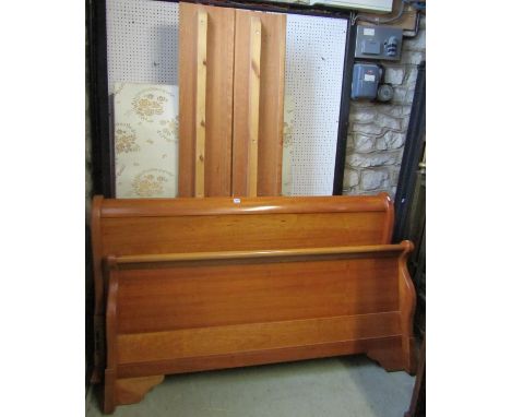 A contemporary cherry wood sleigh bed complete with two sectional base mattress and side adjoining rails 