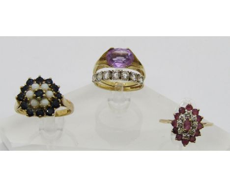 Four vintage 9ct gem set dress rings to include an oval claw set amethyst solitaire ring, maker 'JB', a ruby and diamond clus