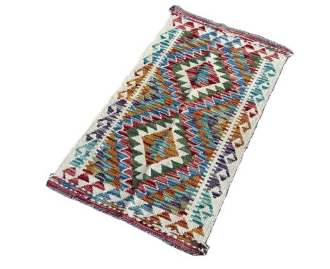 A Chobi kilim mat with a stepped diamond pattern 99cm x 57cm 