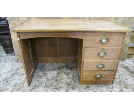 A vintage stripped oak kneehole pedestal desk fitted with four long drawers within a panelled frame, 76 cm high x 122 cm x 67