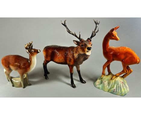 A collection of ceramic figures comprising a Royal Doulton Stag, a Beswick deer and a further Beswick Elk (3)