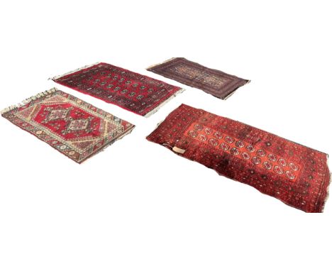 Three Afghan rugs, principally in red with patterned fields and within running borders and a fourth blue rug, 150cm x 95cm , 