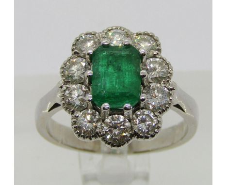 18ct white gold emerald and diamond cluster ring, the emerald 7.5 x 5.5mm approx, the ten diamonds 0.15ct each approx, size P