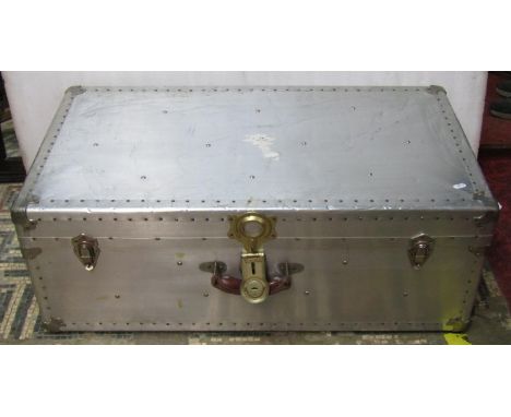 A vintage aluminium travelling trunk with stitched leather carrying handles 33 cm high x 92 cm x 50 cm 