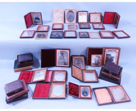 A collection of Victorian miniature portrait photographs, all mostly held in frames within leather bindings