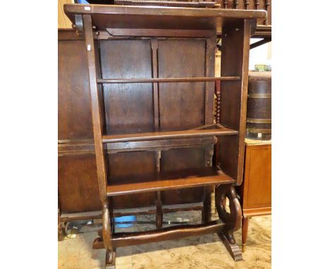 A substantial oak floorstanding open bookcase with pegged frame, shaped supports and sledge feet, 157 cm high x 106 cm x 40 c