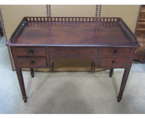 A 19th century mahogany side/dressing table with raised three quarter pierced gallery over an arrangement of five frieze draw