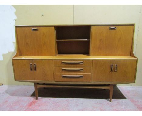 A G-Plan Fresco mid 20th century teak sideboard enclosed by an arrangement of drawers and cupboards, cocktail cabinet, etc, 1