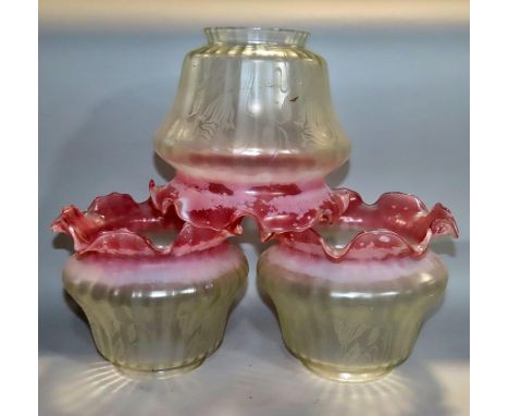Twelve pink tinged glass light shades 18cm diameter and one other opaque glass shade 