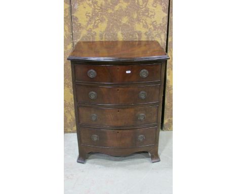 A reproduction mahogany bow fronted chest in the Georgian style of four long graduated oak lined drawers with shaped apron an