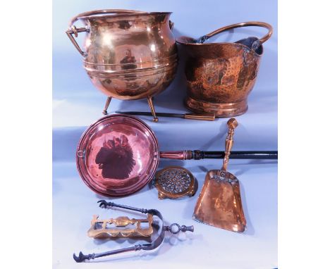 A 19th century brass coal scuttle, a brass cauldron, copper warming pan and a selection of fireside tools