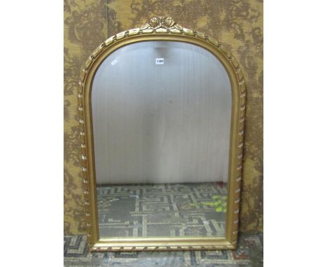 A contemporary reproduction gilt framed wall mirror of arched form with bevelled edge plate with moulded surround, 105 cm x 7