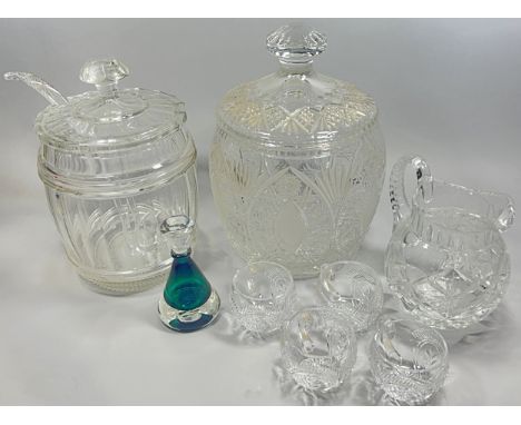 A large cut glass punch bowl with cover and ladle and four glasses a large cut glass storage jar, a water jug and a green gla