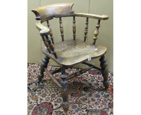 A late Victorian Windsor smokers bow elbow chair principally in elm 