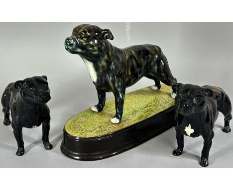 Three Beswick figures of Staffordshire Bull Terriers, one set upon a plinth (3)