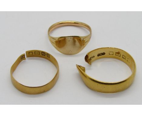 Two 22ct wedding rings, 6.2g total (both cut) and a yellow metal signet ring, size J/K, 1.4g (3)