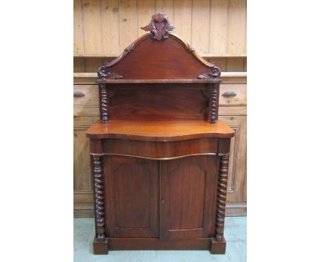 A small Victorian mahogany chiffonier with serpentine outline on barley twist supports 