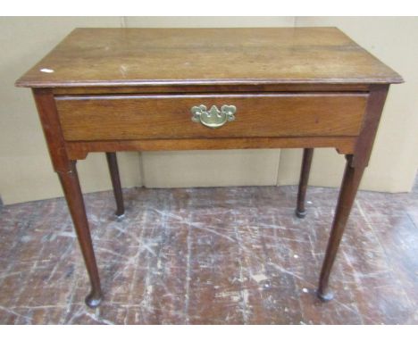 A Georgian oak pad foot side table enclosing a single frieze drawer, 75cm x 42cm