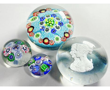 A Bacarat style millefiori cane paperweight, two smaller examples and a paperweight with Queen Victoria and Prince Albert’s p