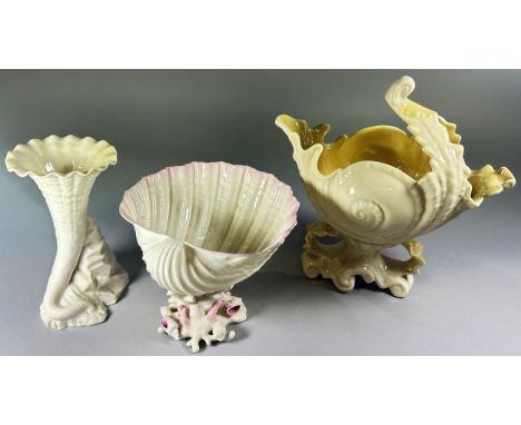 A Belleek porcelain shell form bowl on coral ground, 11cm high, 14cm diameter, together with a horn form posey vase, 14cm hig