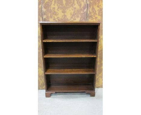 An oak freestanding open bookcase with three adjustable shelves set on bracket supports 120 cm high x 82 cm x 25 cm 