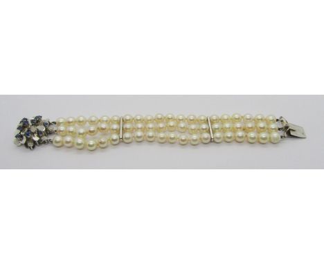 Vintage triple row pearl cuff bracelet with two vertical spacers and stylised 14k white gold sapphire cluster push clasp, wit