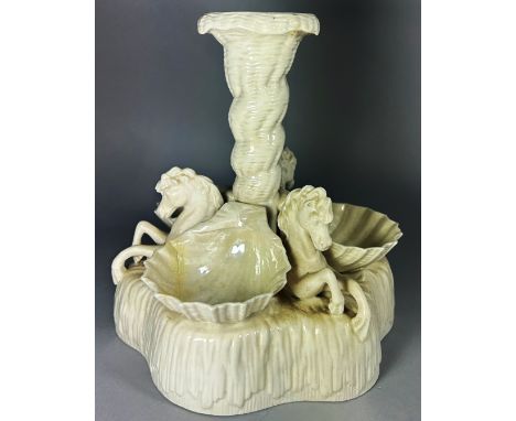 A Belleek first period porcelain pedestal centrepiece or comport, modelled with three scallop shell dishes between horses, 21