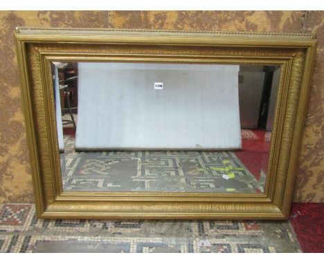 A bevelled edge mirror plate enclosed within a 19th century overgilded rectangular stepped and cushion moulded frame, 78 cm x