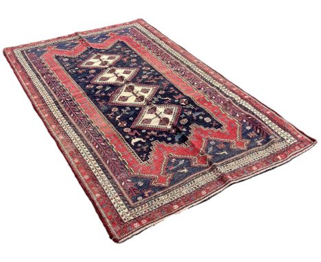 A North East Persian Sumak Kilim, with four interlocking diamonds on a blue ground interspersed with stylised animals,240cm x