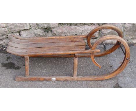 A vintage ashwood toboggan with slatted seat 