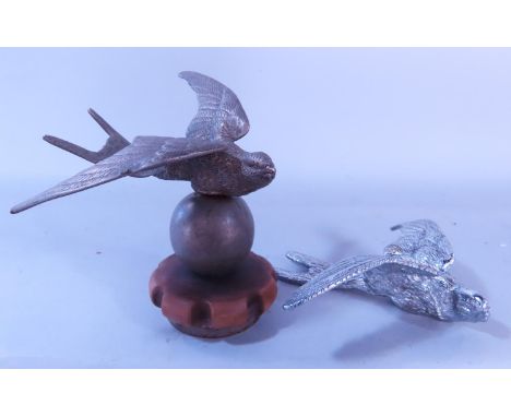 A bird radiator cap mascot, together with a chrome plated Swallow car mascot