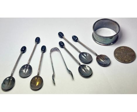 A cased set of six silver coffee bean spoons and tongs, a single napkin ring and an 1889 Florin coin, 2.6 oz