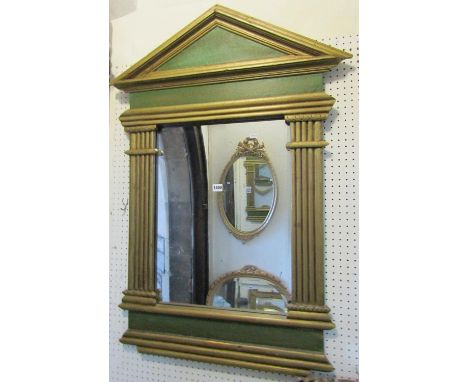 A decorative wall mirror of architectural form with rectangular plate flanked by split moulded columns and pointed arched ped