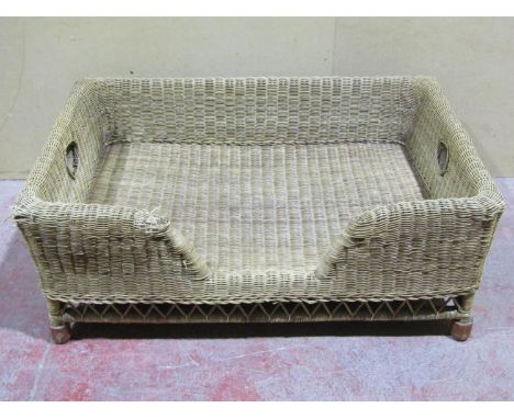 A country house wicker dog bed, 41cm high x 104cm wide x 80cm deep (af)