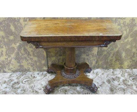 A 19th century mahogany fold-over top card table raised on a turned pillar with pestle collar, shaped platform and scrolled s