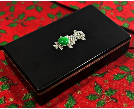 A Cartier silver and black enamel box, the hinged cover set with green jade and diamonds in the Art Deco style, enclosing a s