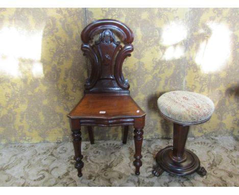 A Victorian mahogany hall chair with carved and moulded shield shaped back and turned forelegs, together with a 19th century 