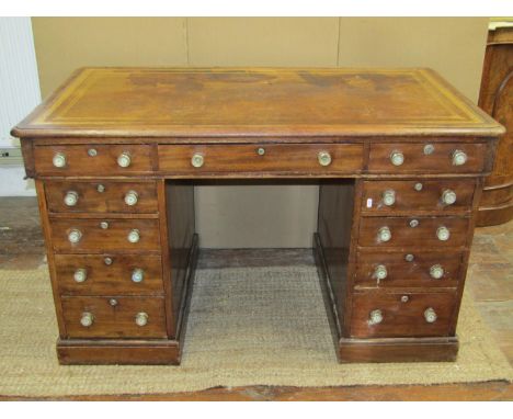 A 19th century mahogany pedestal desk, one side enclosing eleven graduated drawers, the far side with three drawers and two c