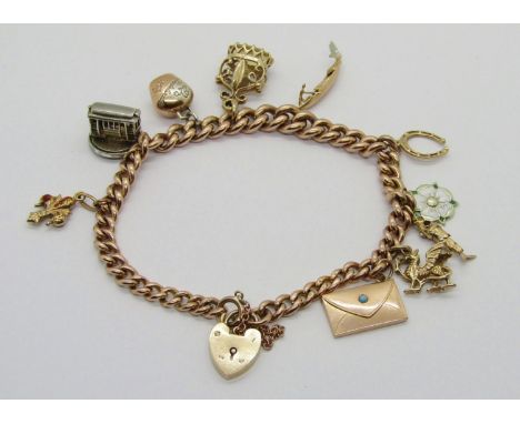 9ct curb link charm bracelet with heart padlock clasp, hung with ten novelty charms to include an 18ct enamelled fleur-de-lis