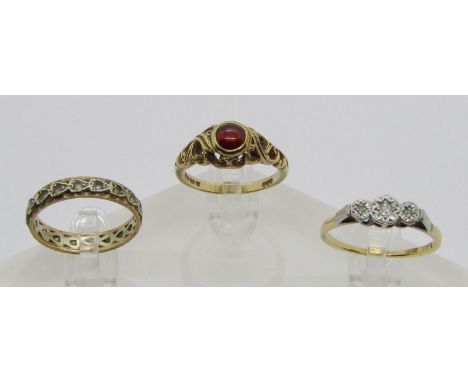 Three gold rings comprising an 18ct illusion set diamond ring, size Q, 2.4g, a 9ct cabochon garnet ring, maker 'PSR', London 