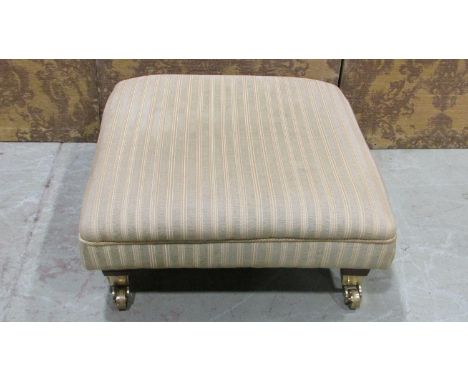 A contemporary low foot stool with striped upholstered seat raised on polished canters, 28 cm high x 65 cm square approximate