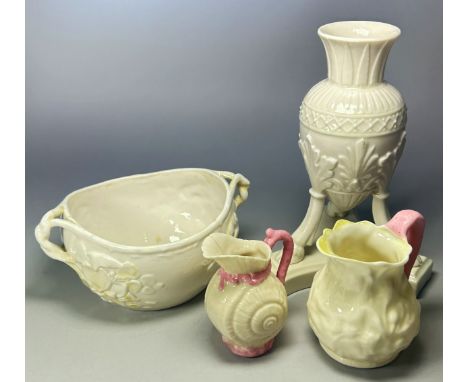 A group of Belleek porcelain to include an urn shaped vase on bacchanalian supports and trefoil base, 18cm high, a twin handl