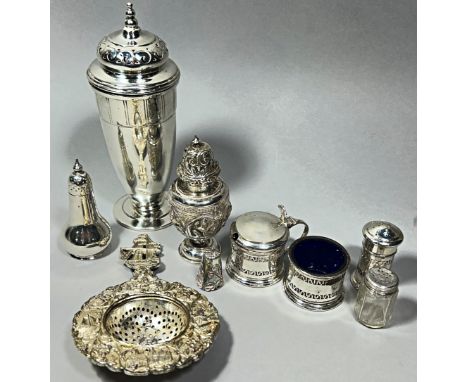 A mixed selection of silverware including a Mappin &amp; Webb silver sugar caster, an assortment of silver condiments, a thim