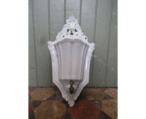 An Italian ceramic water font, with scrolling foliate detail
