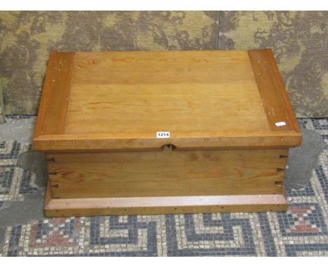 A vintage shallow stripped pine chest with hinged lid exposed dovetail construction and bound drop carrying handles, 27cm hig